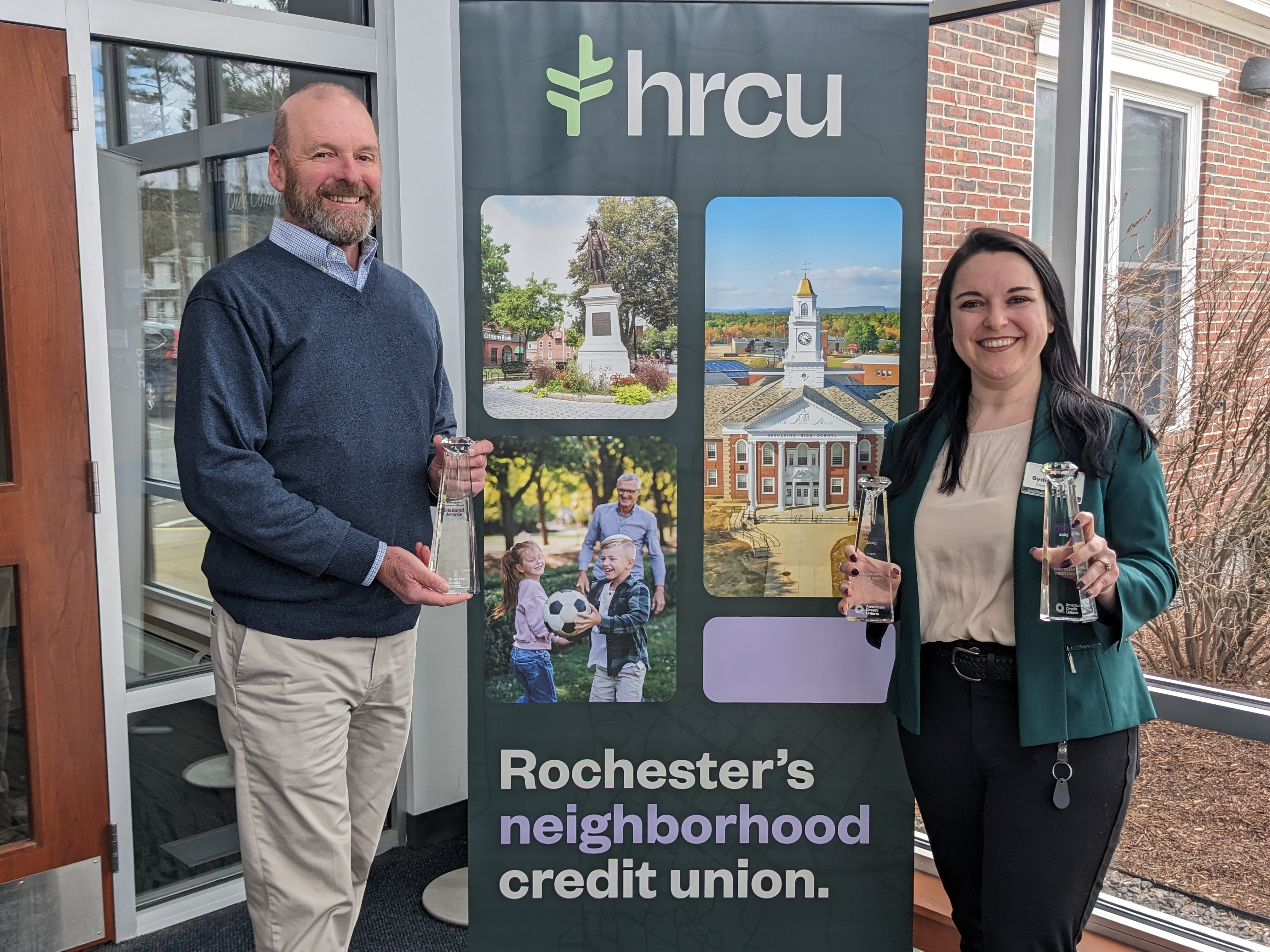 <p>HRCU CEO Brian Hughes and Director of Marketing Sydney Albee pictured with three awards received at the annual competition.</p>